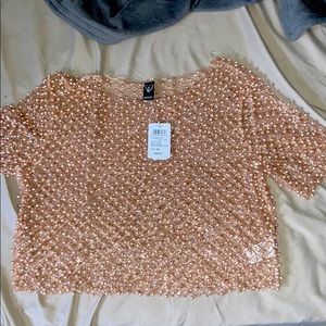 A rose gold beaded top